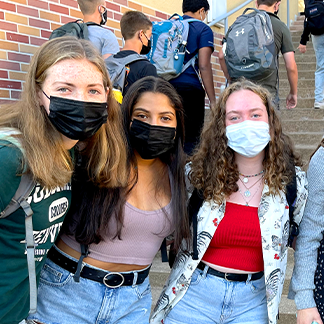 three girls wearing facemasks